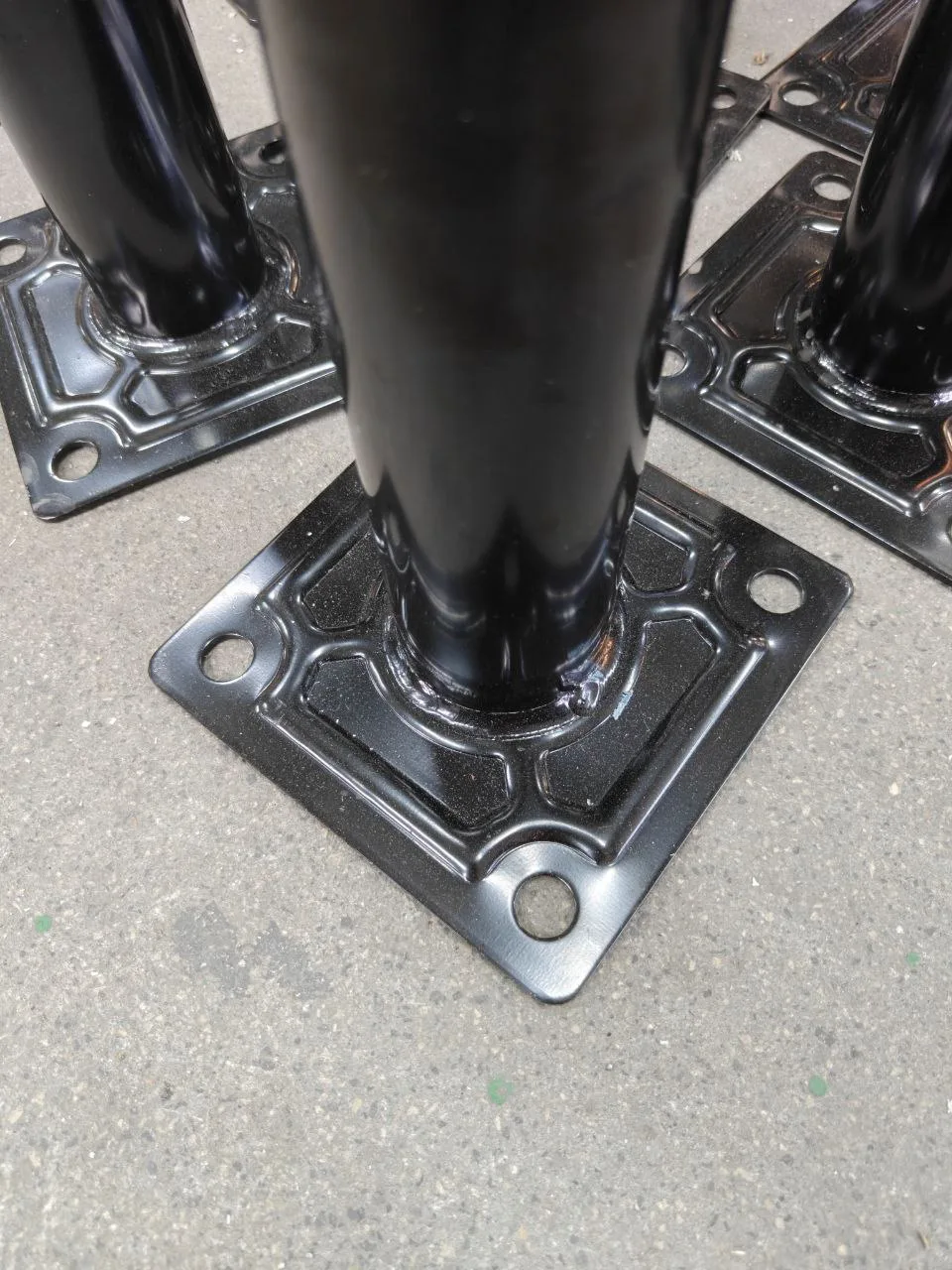 Before: a photo of a table leg's stamped base plate